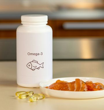 Omega-3 supplements and fresh salmon on a table, highlighting natural sources for men's health