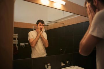 Tired Man Contemplating Supplements for Energy Boost